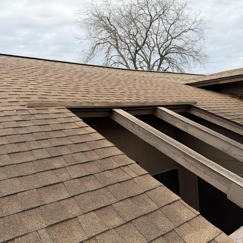 Asphalt shingle roof with exposed wooden beams