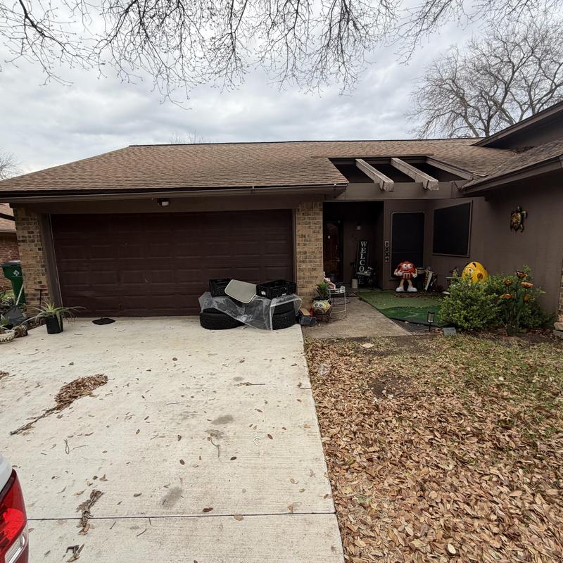 Asphalt shingle roof and driveway with garage door