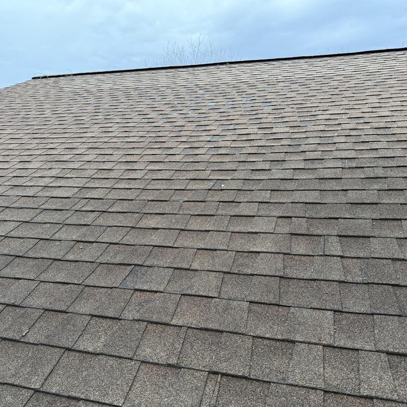 Asphalt shingle roof close-up with hail impact marks