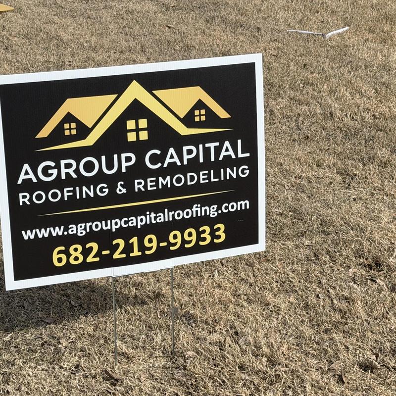 Roofing company yard sign on dry grass