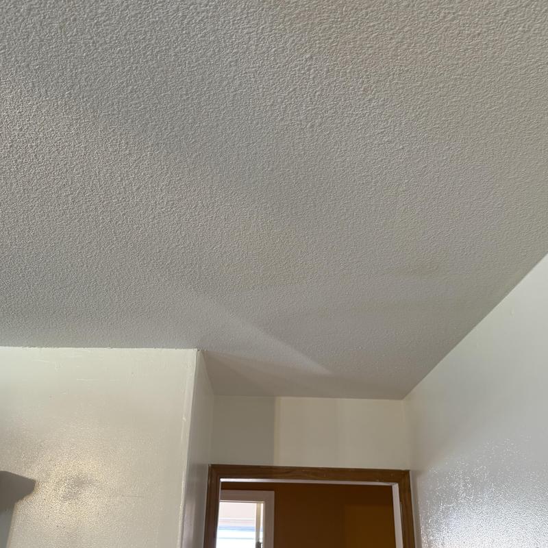 Popcorn ceiling texture patch above doorway interior