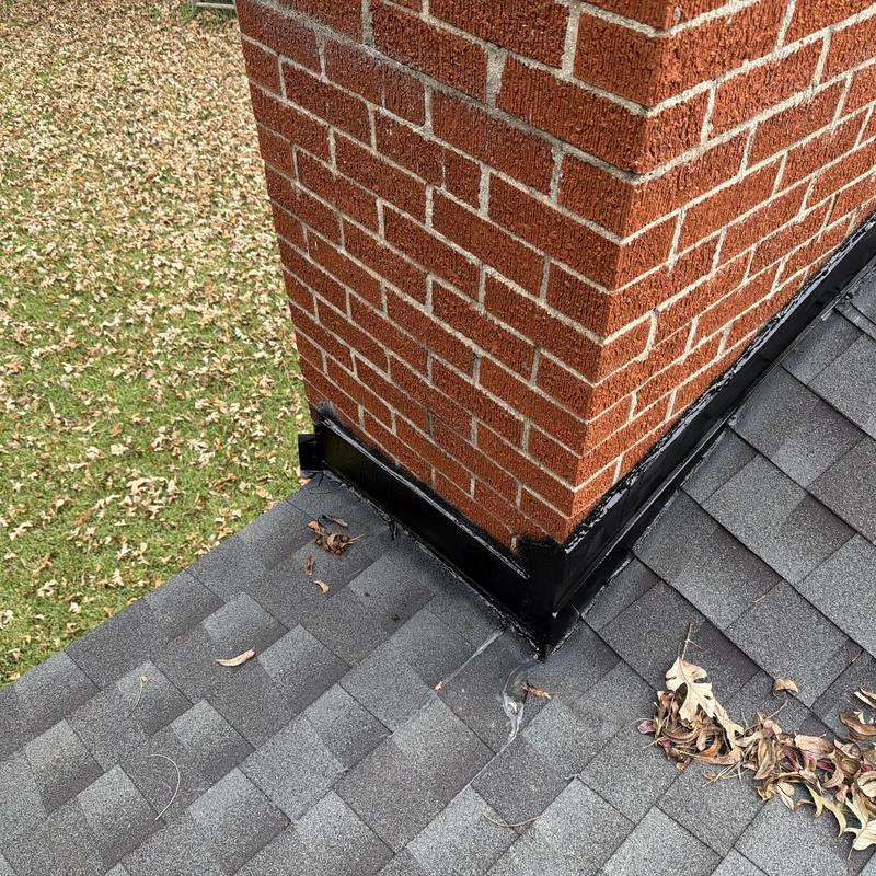 Chimney base flashing installation on asphalt shingle roof