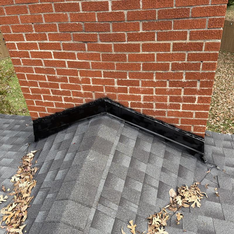Chimney roof flashing with sealed black tar in Fort Worth
