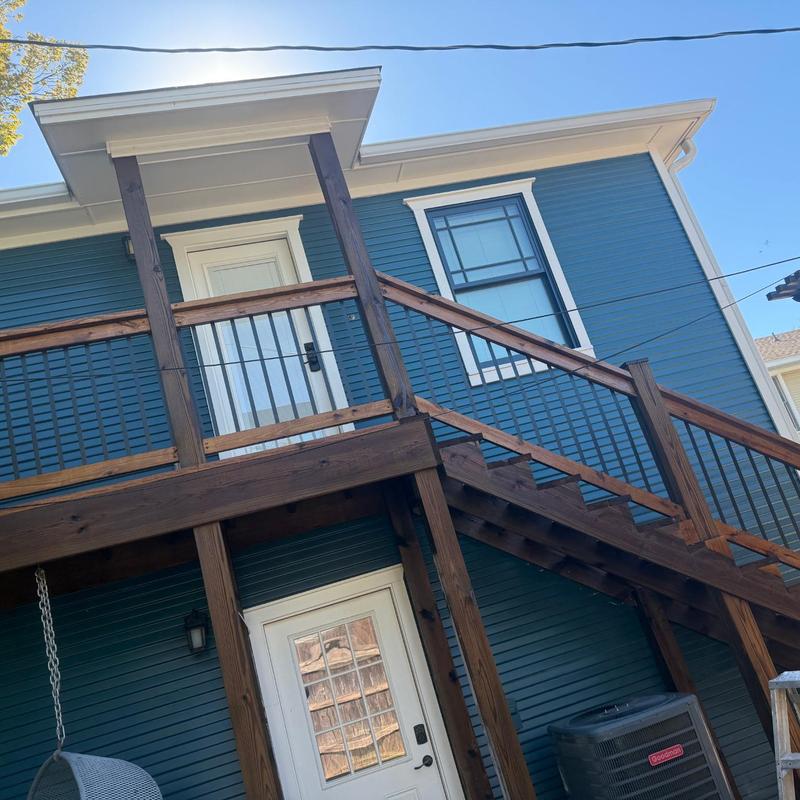 Wooden exterior stairs with railing and re-stain