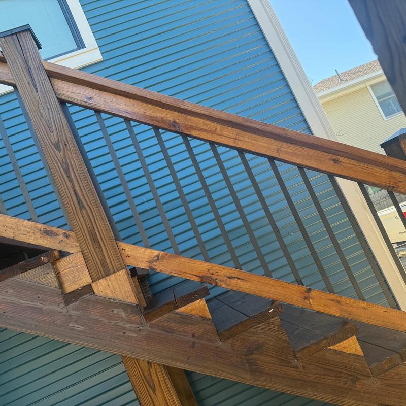 Wooden garage apartment exterior stairs with railing