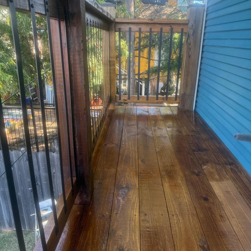 Wooden garage apartment outside stairs and railing stained