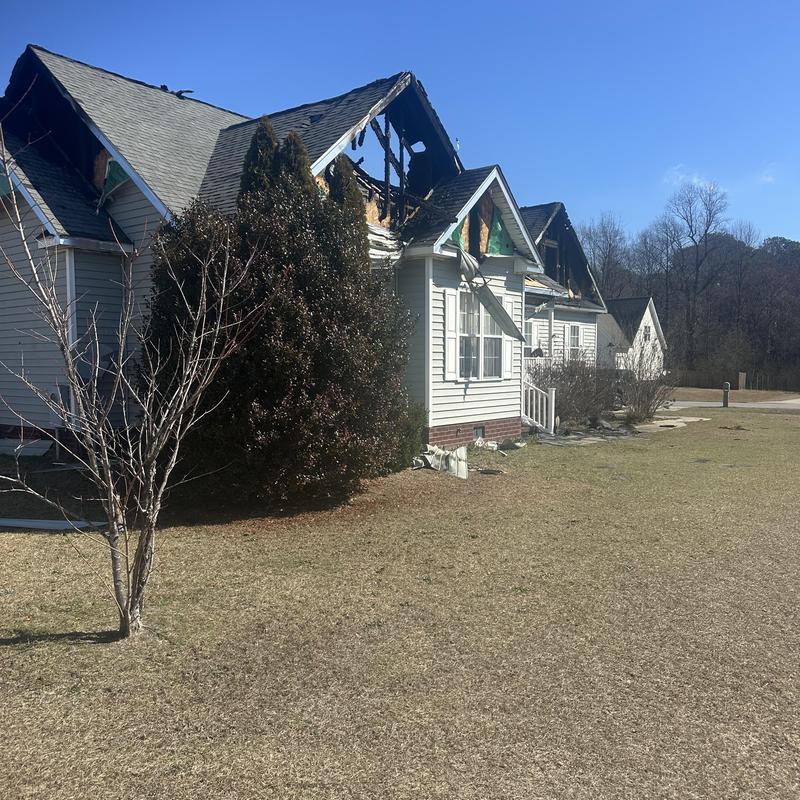 Roof and siding fire damage on residential house exterior Roof and siding fire damage on residential house exterior