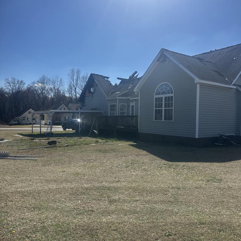Roof and siding damaged by fire after house burn Roof and siding damaged by fire after house burn