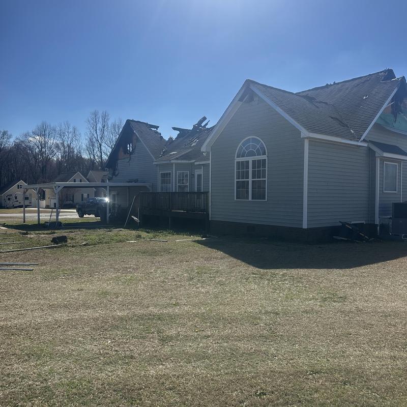 Burned roof and siding damage on residential house Burned roof and siding damage on residential house