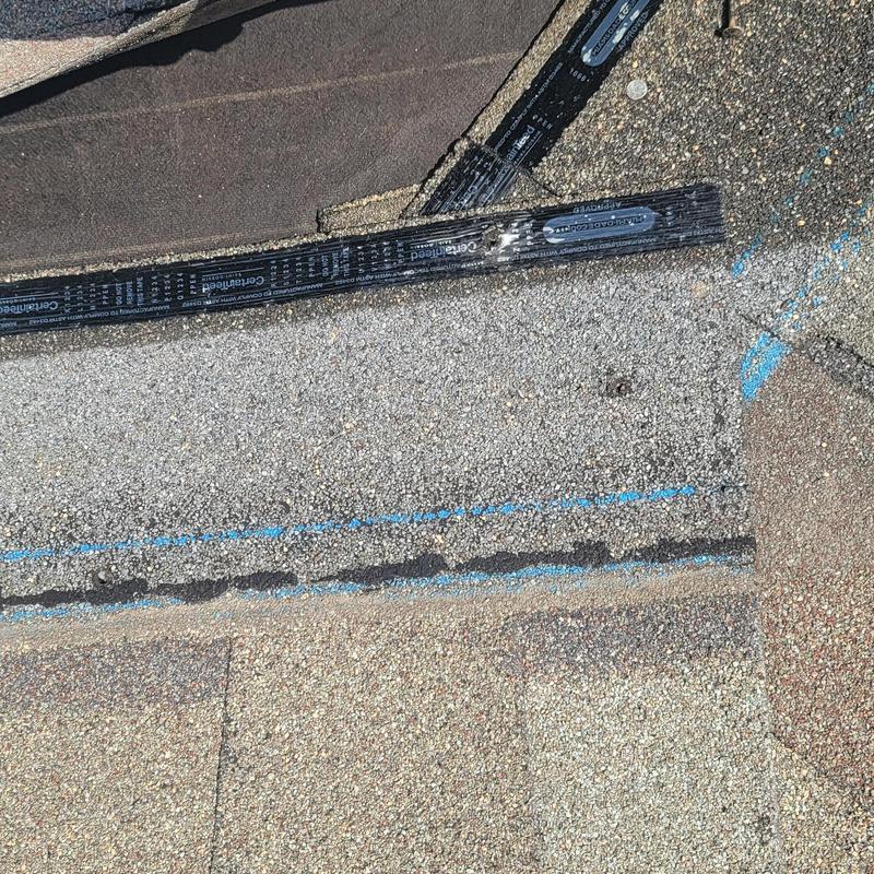 Asphalt shingle roof with hail damage and markings