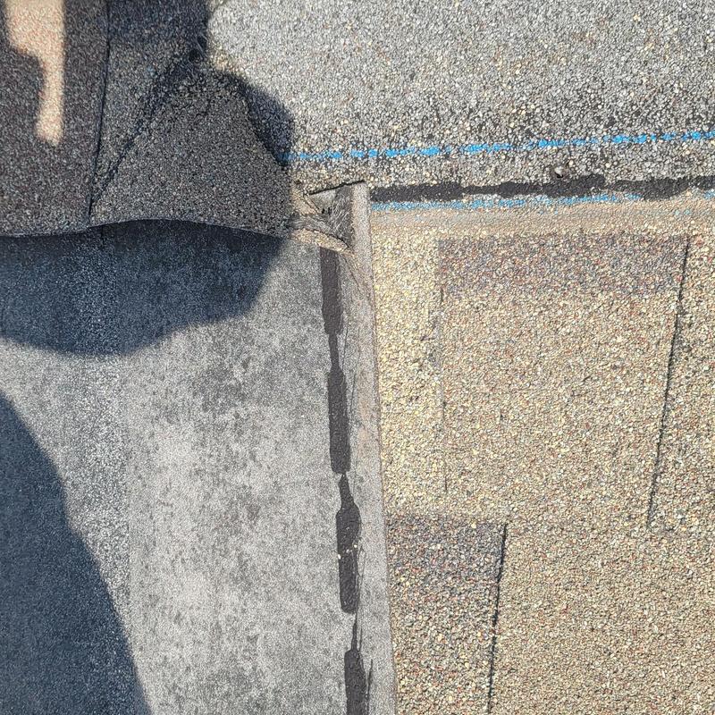 Asphalt roof shingles with hail damage close-up