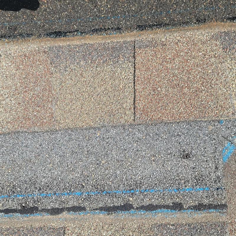 Asphalt shingles with hail damage and chalk markings