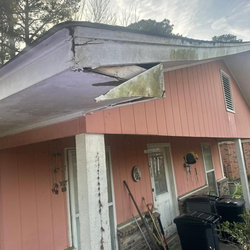 Fascia board with water damage and rot on porch roof