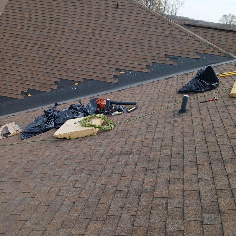 Asphalt shingle roof with repair tools and materials
