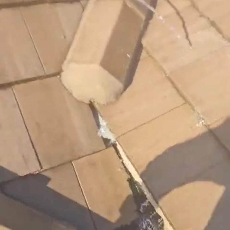 Concrete tile roof with cracked ridge cap and gaps