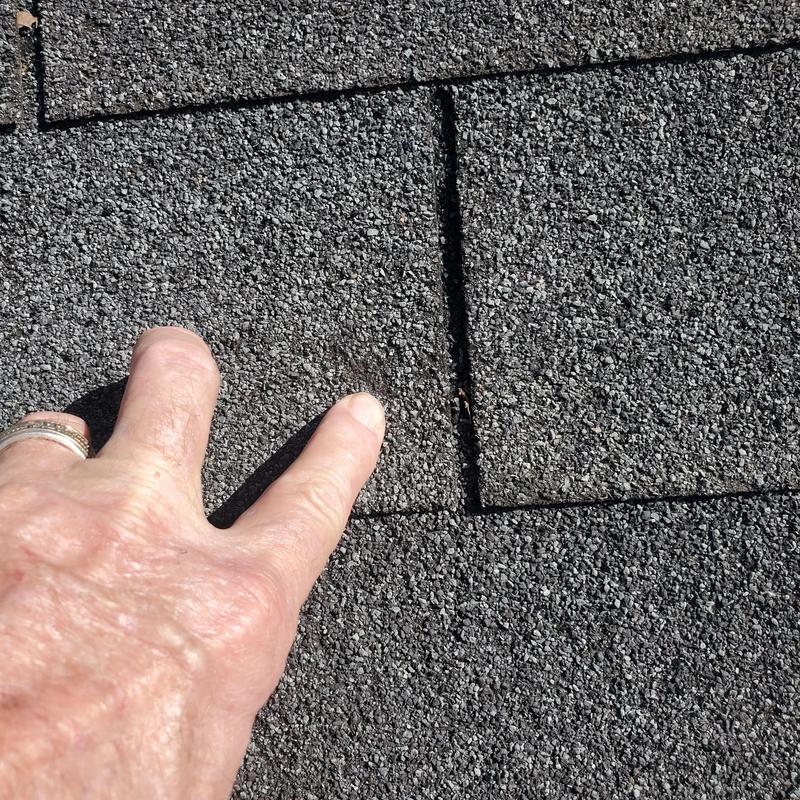 Asphalt roof shingles with wind and hail damage