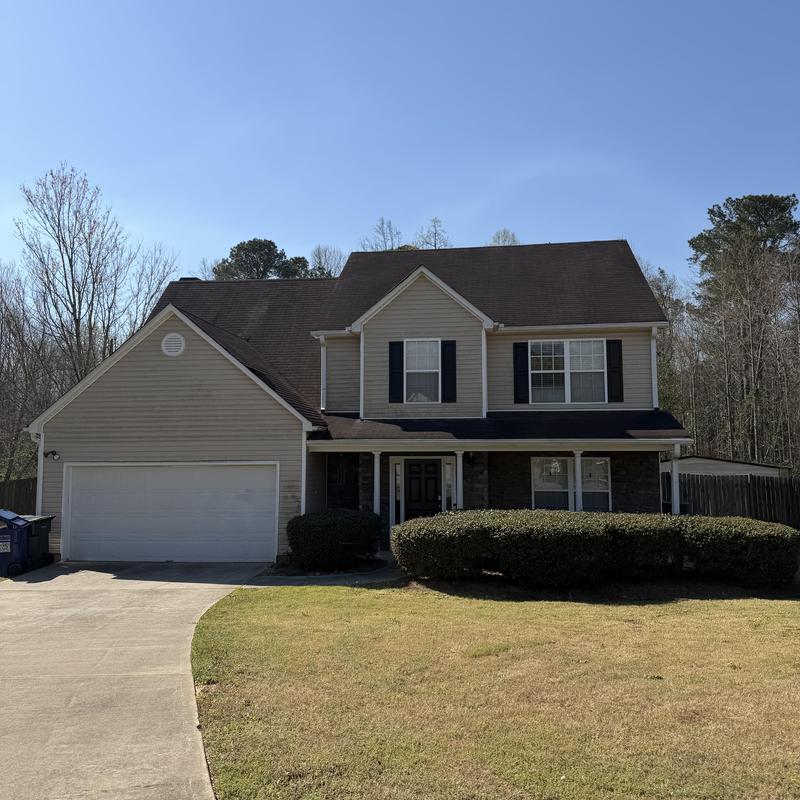 Three-tab roof with tarp over missing shingles