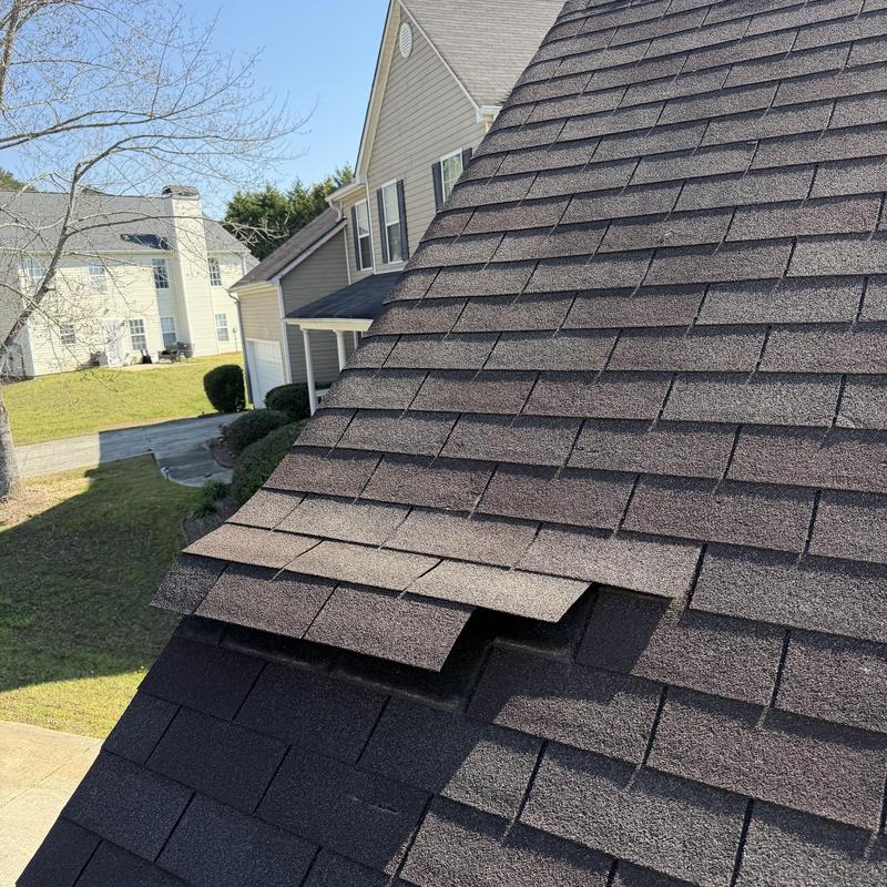 Three-tab roof with lifted and missing shingles