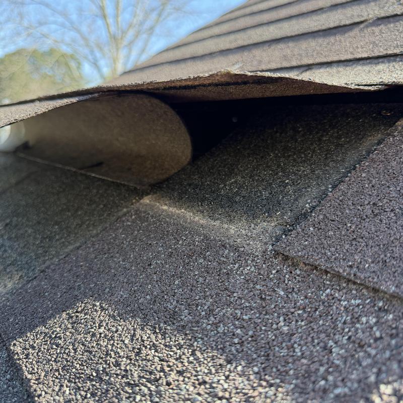 3-tab roof shingles with lifted and missing sections