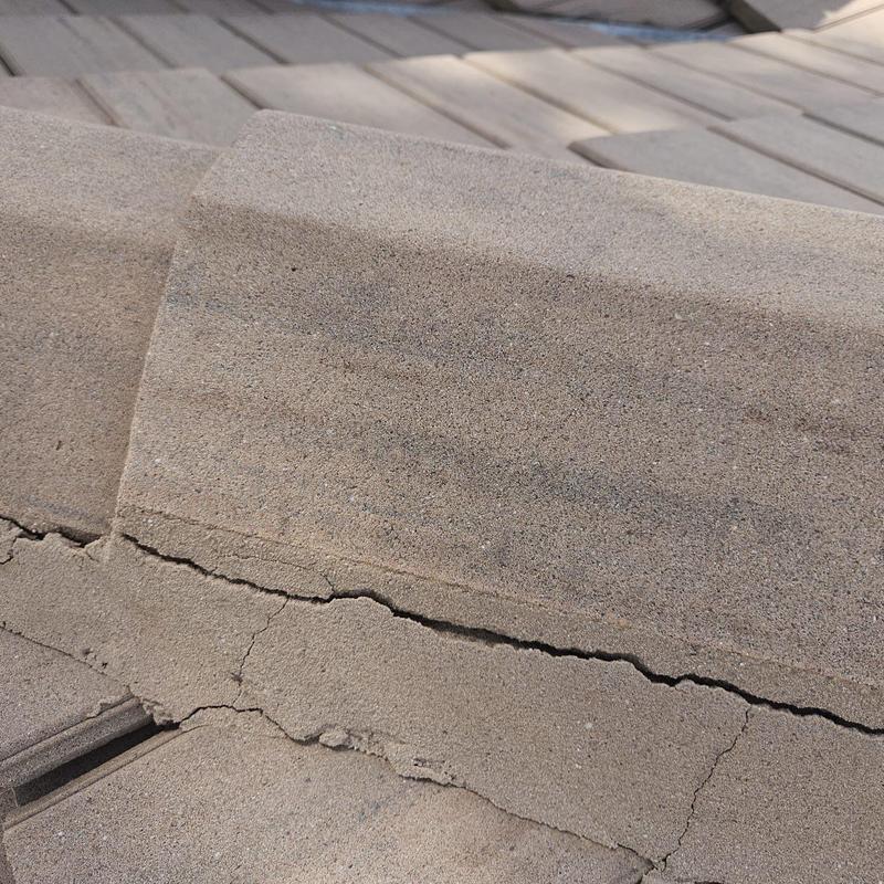 Concrete tile roof with visible crack damage