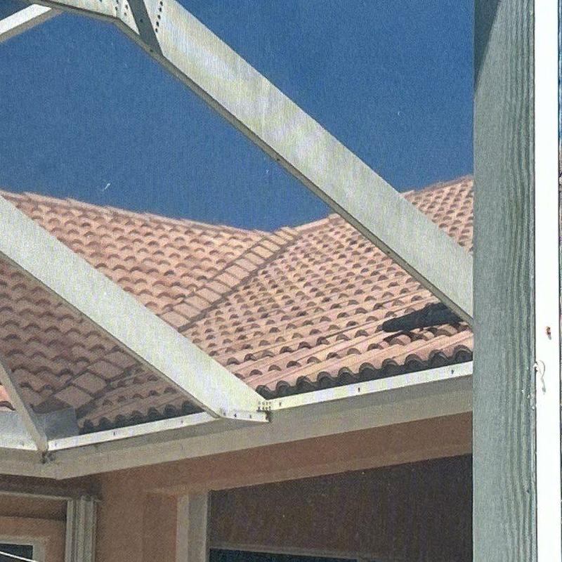 Concrete tile roof under screened patio frame in Cape Coral