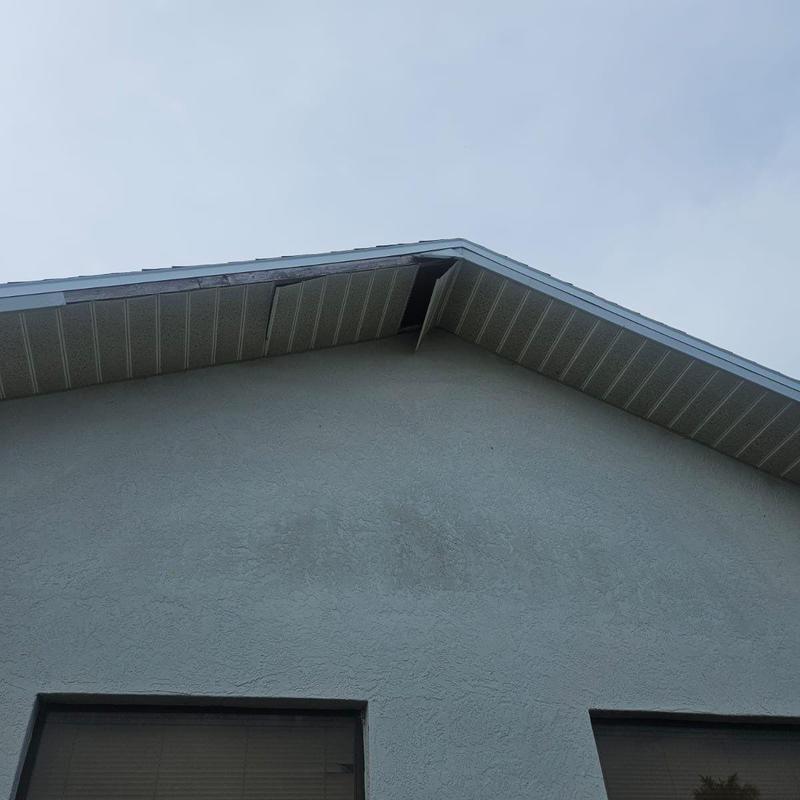 Soffit with missing panels and damaged fascia