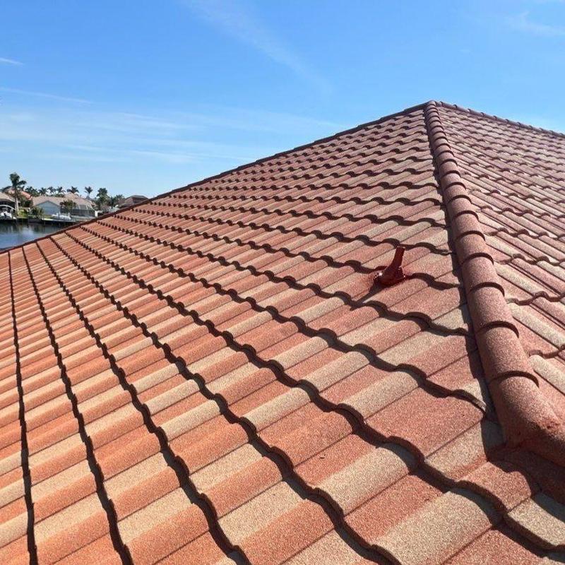 Stonecoated steel tile roof with ridge cap installation