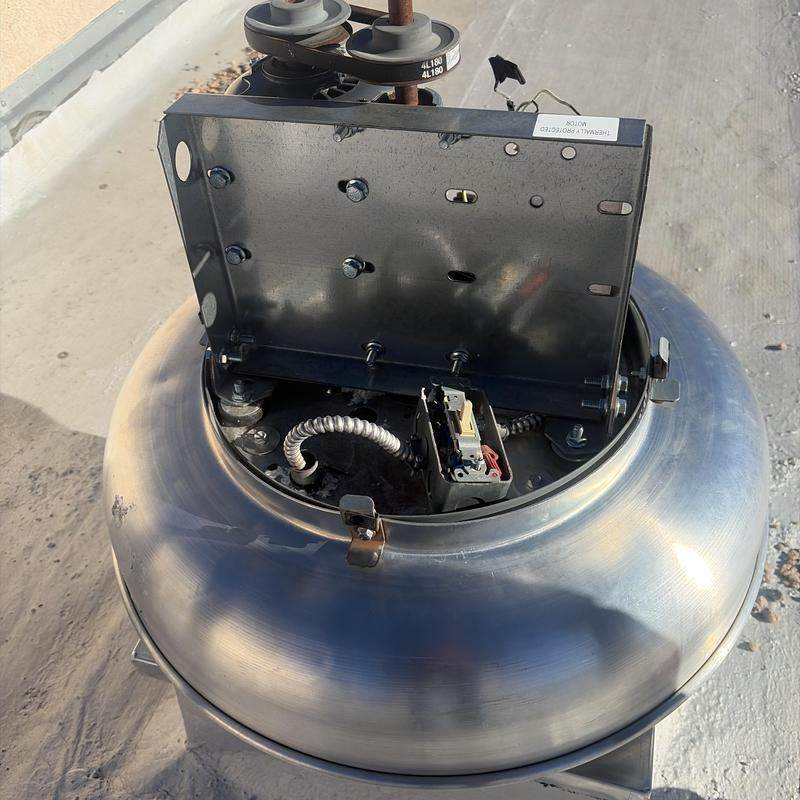 Roof exhaust fan motor and wiring components on rooftop