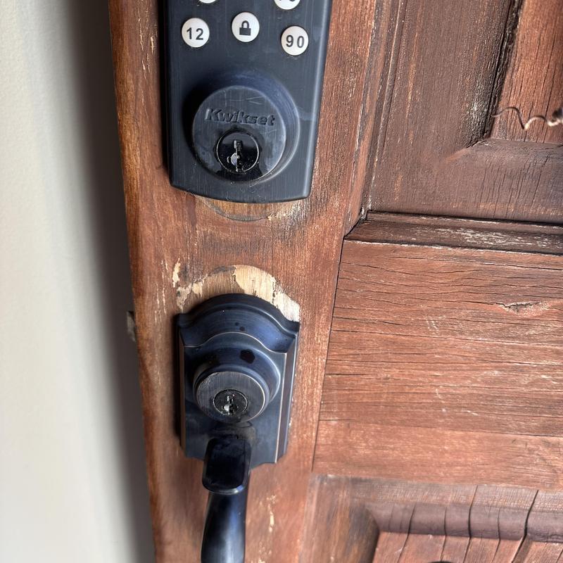 Keypad door lock and deadbolt on wooden door