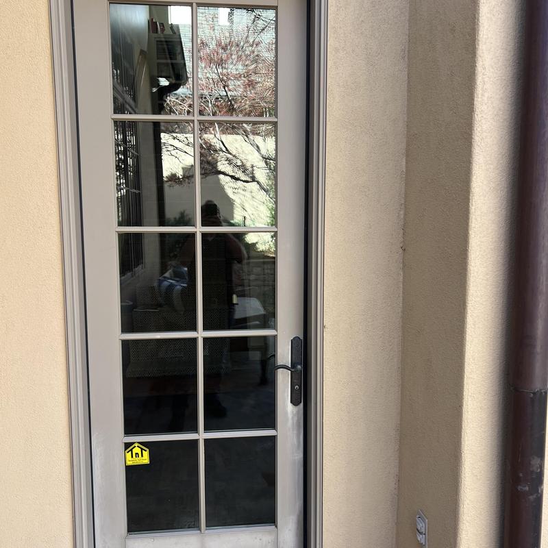 Multipoint lock on glass panel door in frame