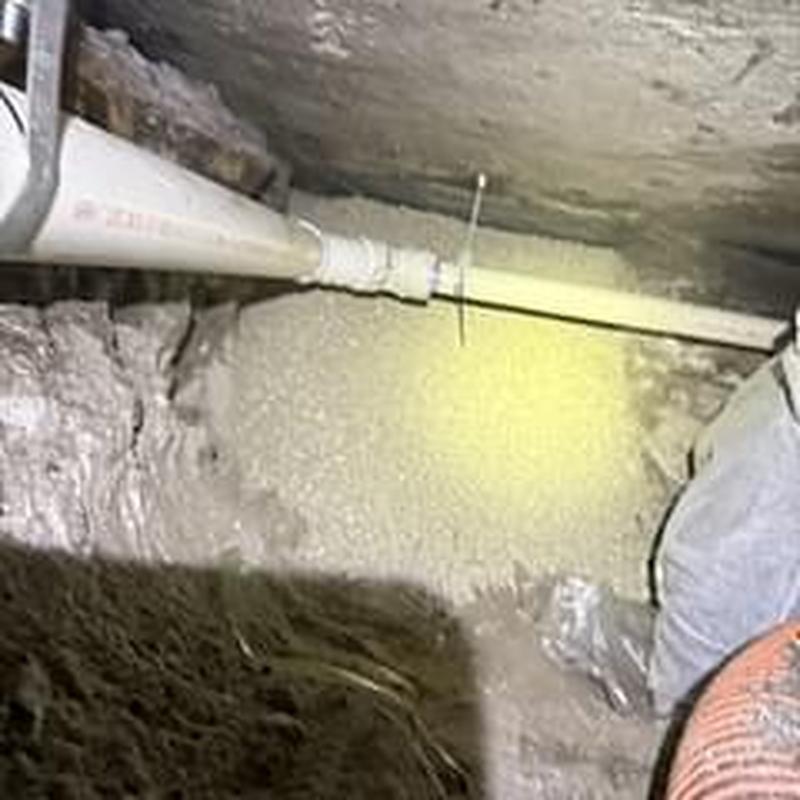 PVC drainage pipe installation in crawl space