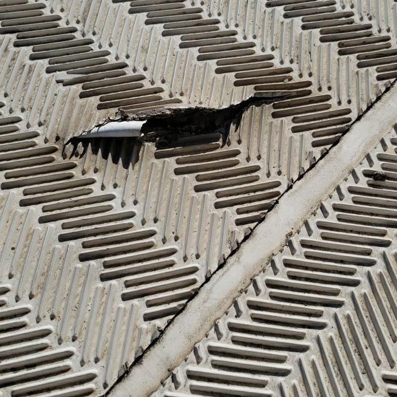 TPO flat roof membrane with perforation damage TPO flat roof membrane with perforation damage