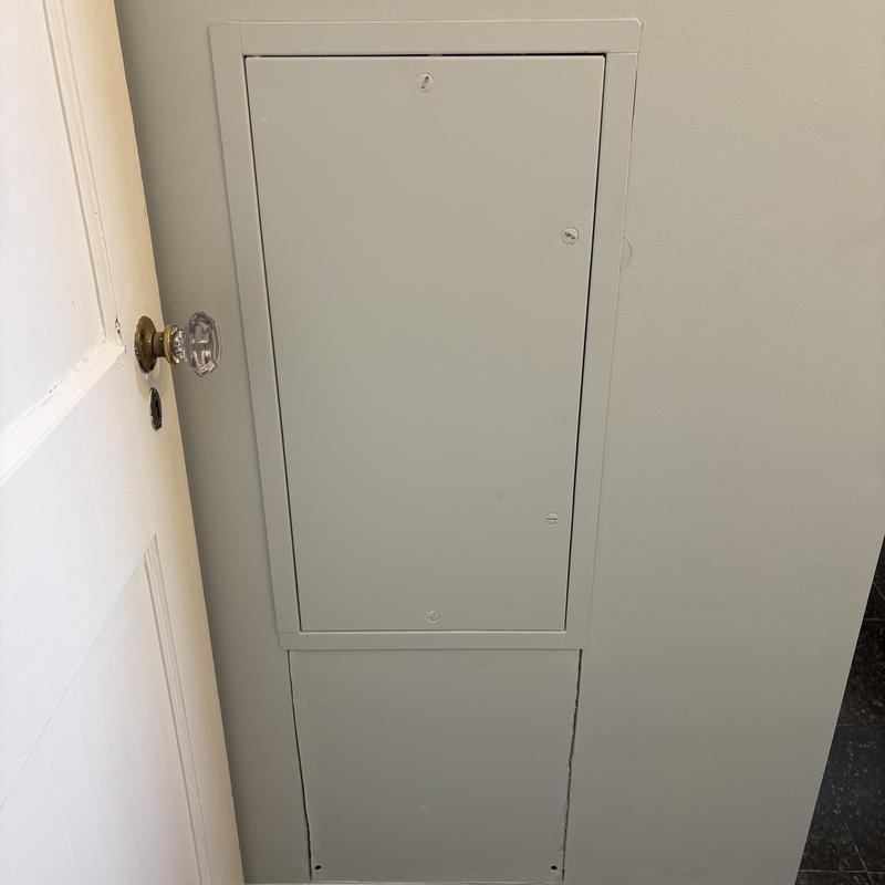 Electrical breaker panel box flush against wall