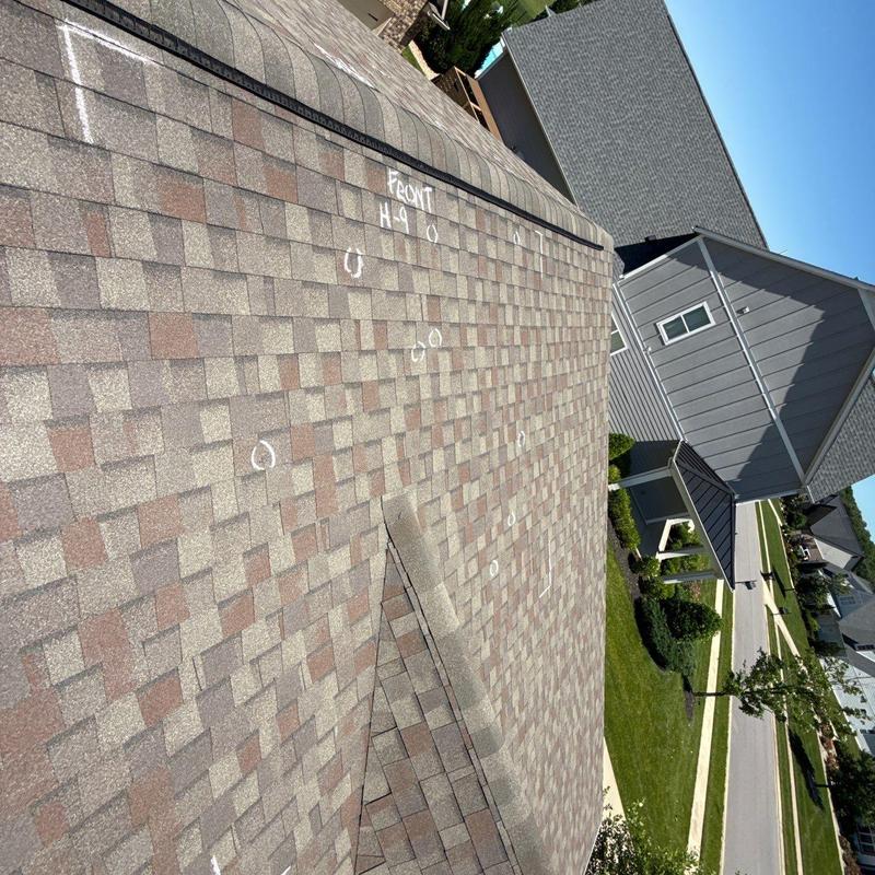 Asphalt shingle roof with hail damage markings