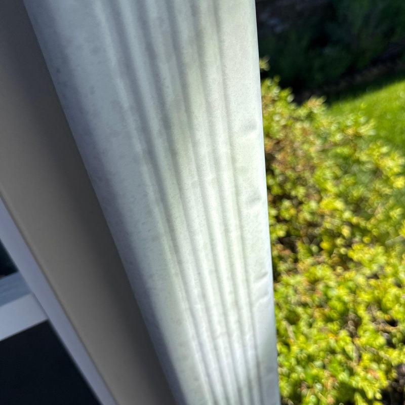 Aluminum gutter with minor dents from hail damage