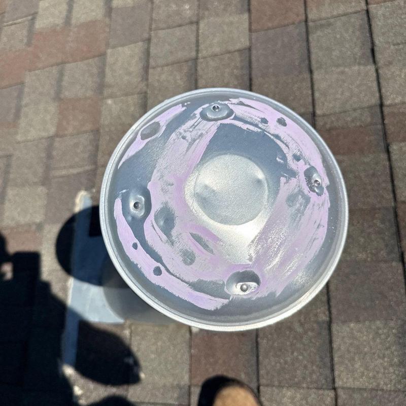 Metal roof vent cap with hail damage marks