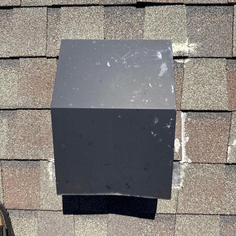 Roof vent on asphalt shingle roof with hail damage