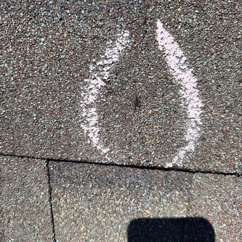 Asphalt shingle roof hail damage marked with chalk