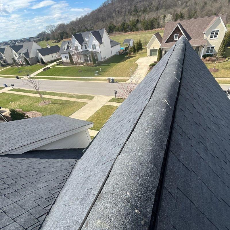 Roof ridge shingles with hail damage and granule loss