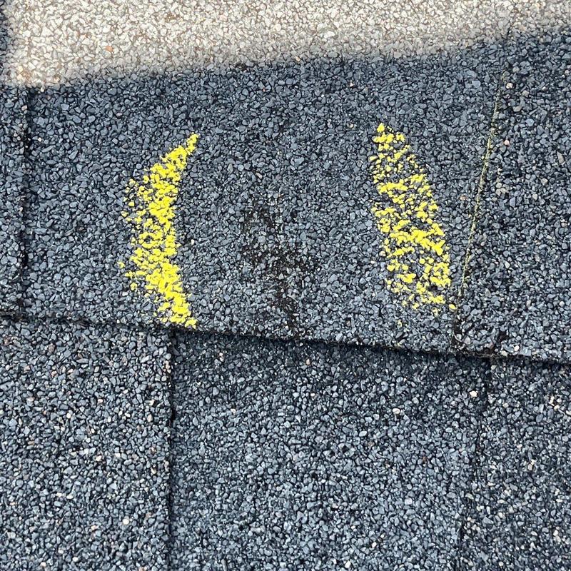 Asphalt shingle hail damage marked for inspection