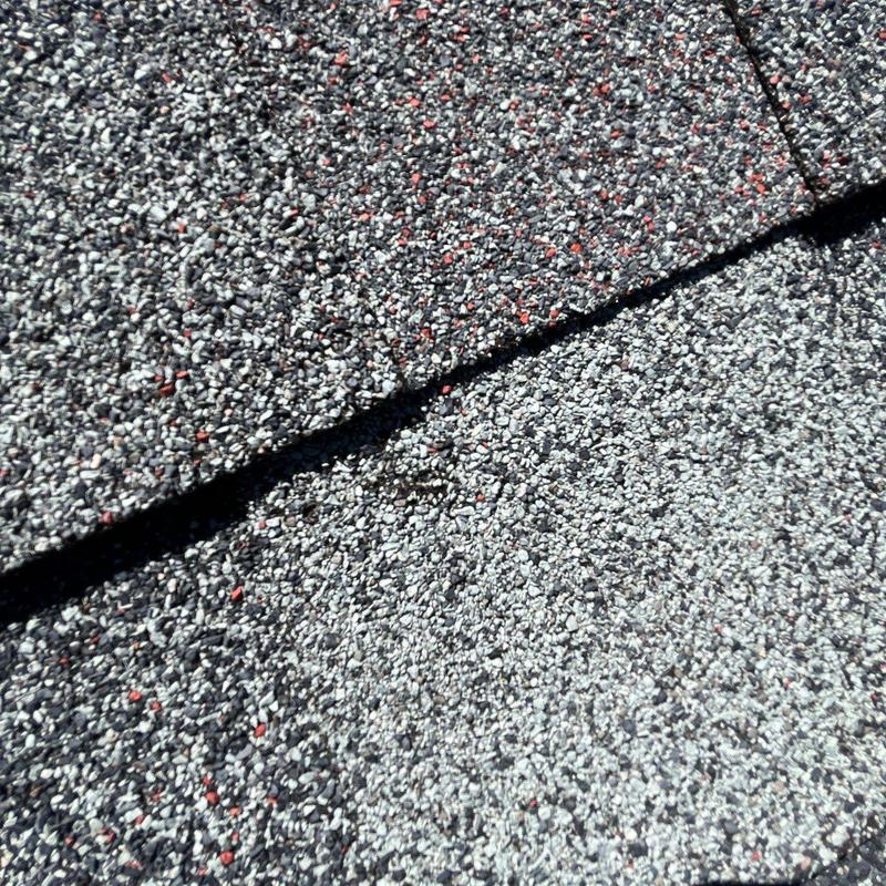 Asphalt roof shingles with hail damage close-up