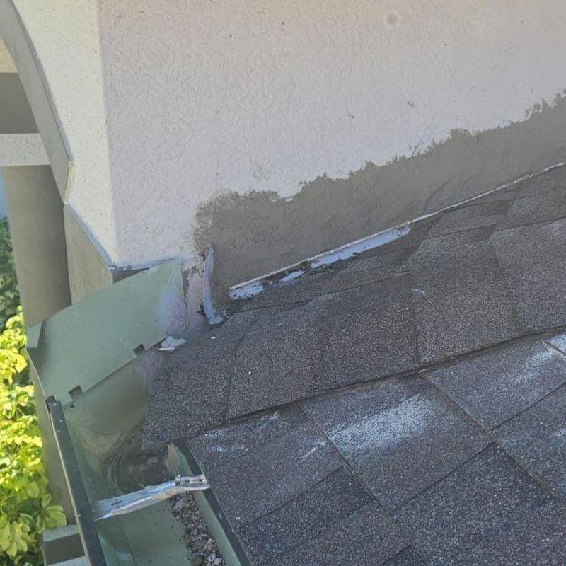 Shingle roof with wall-to-roof flashing repair
