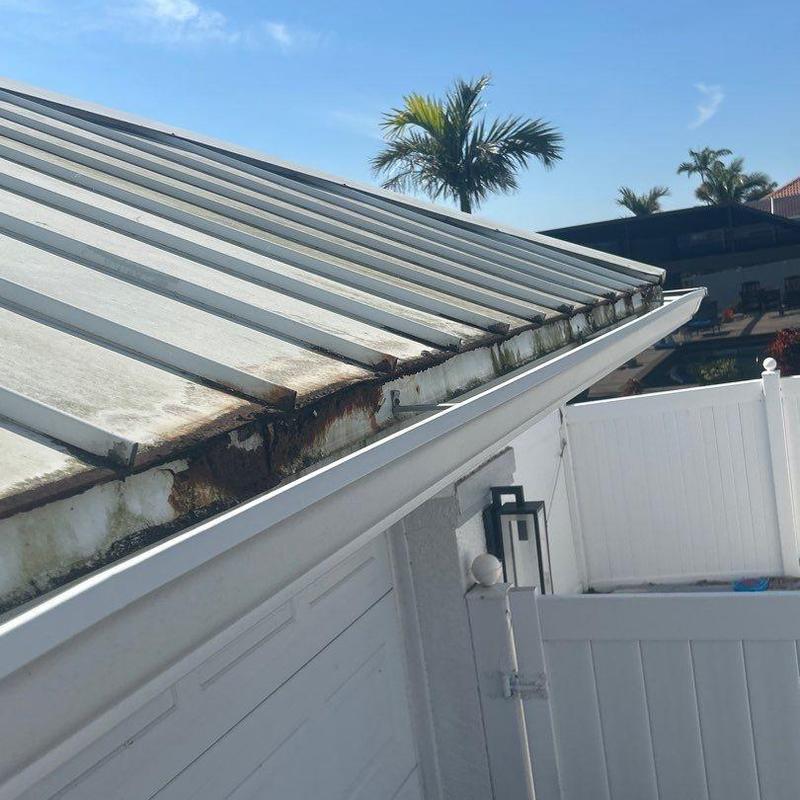 Standing seam metal roof with rust and corrosion damage