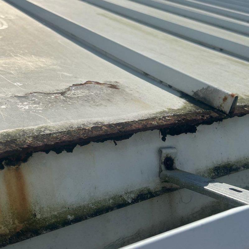 Standing seam metal roof edge with severe rust corrosion