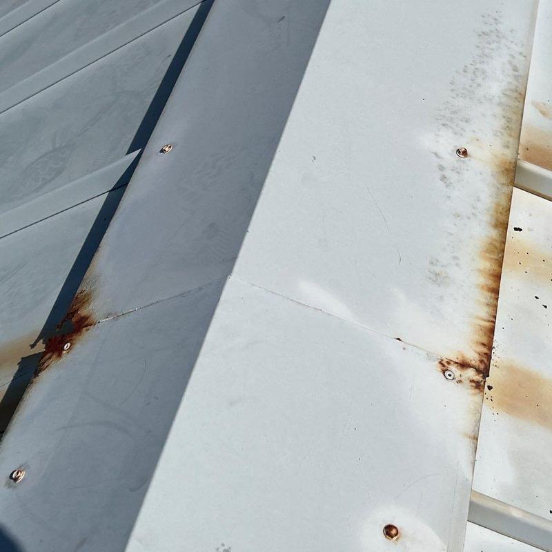Standing seam metal roof rust and corrosion close-up