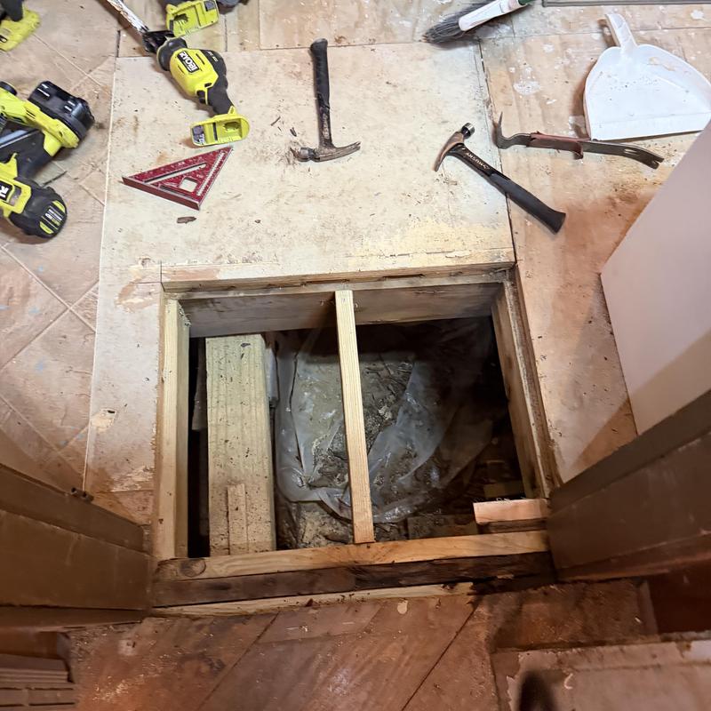 Bathroom floor subfloor with tools during repair