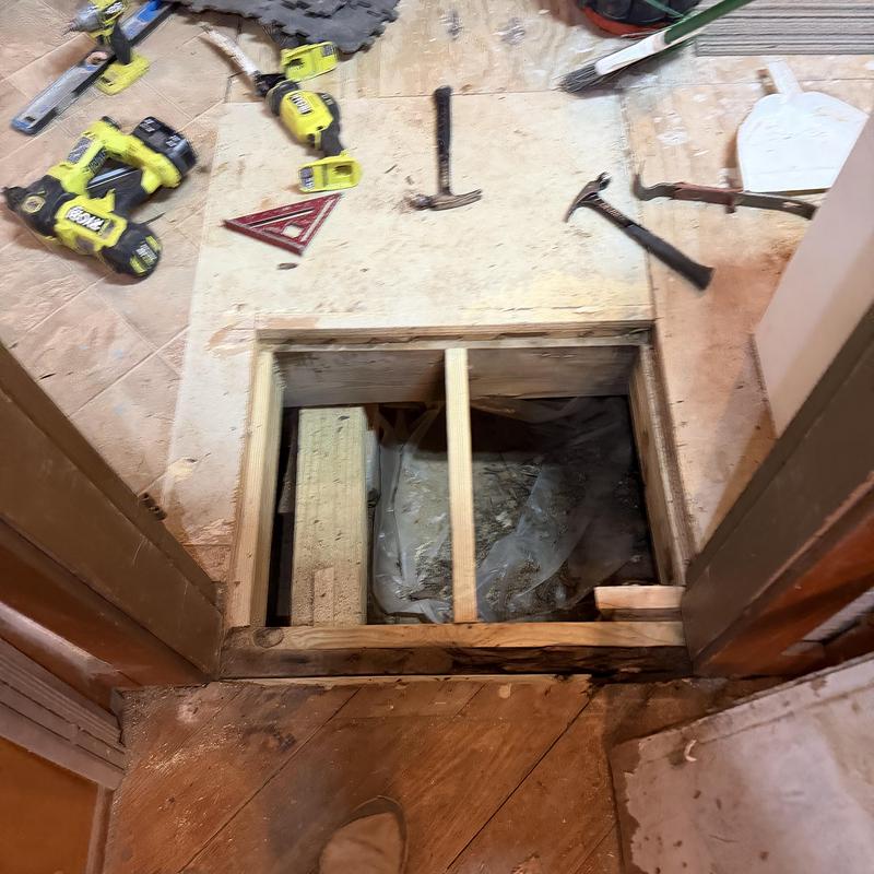 Bathroom floor framing repair with tools and flooring removed