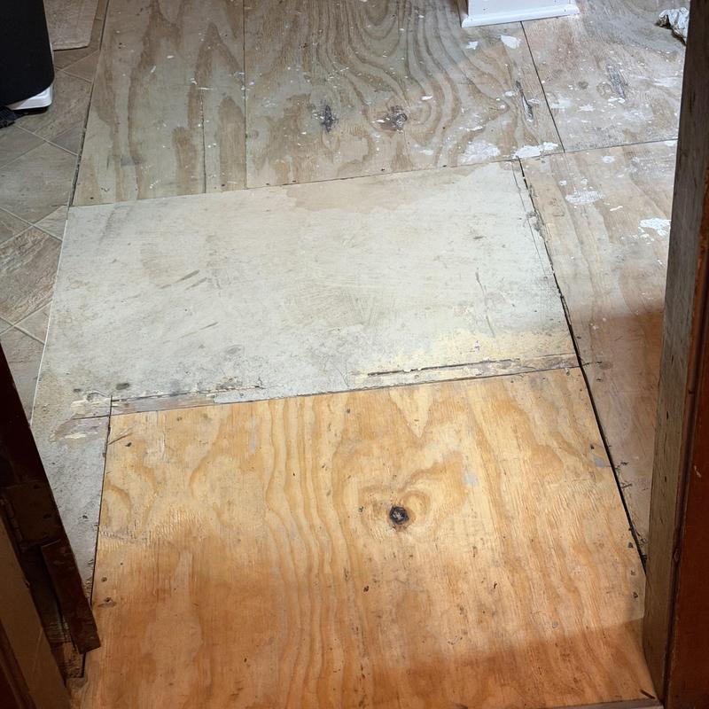 Plywood floor panels in bathroom under repair