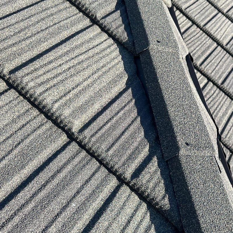 Stonecoated steel roof ridge detail inspection