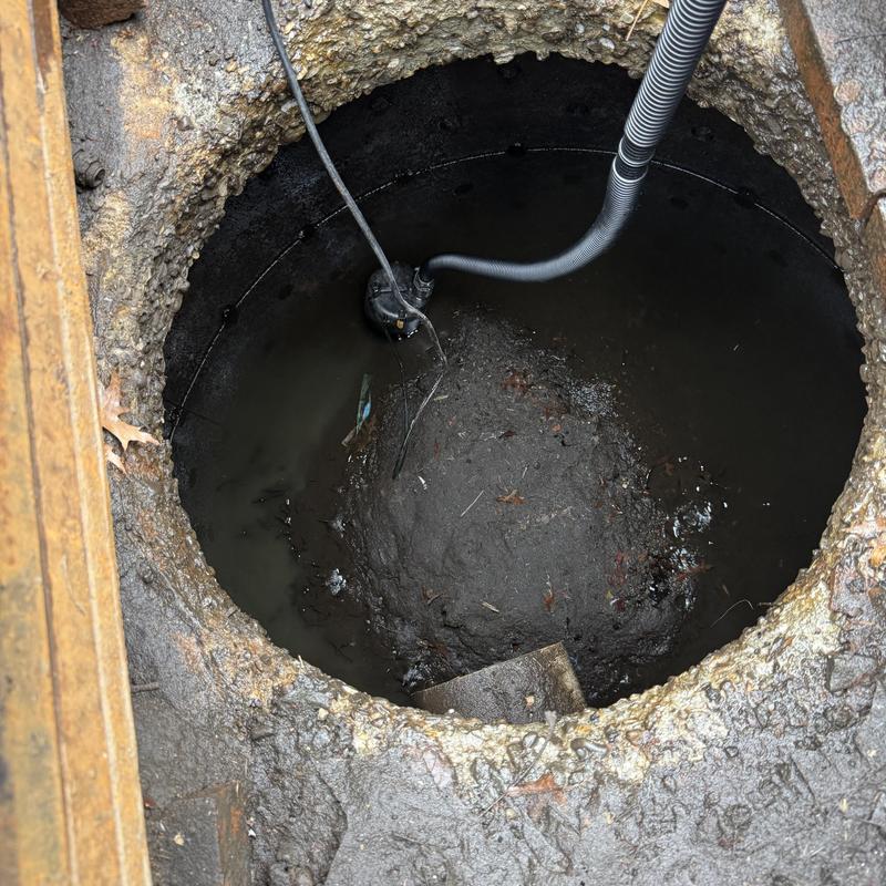 Storm basin with Vactor cleaning hose inserted Storm basin with Vactor cleaning hose inserted